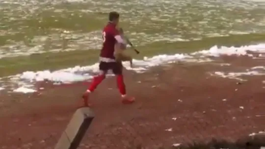 Maçı durduran köpeği futbolcu kucağına alarak çıkardı