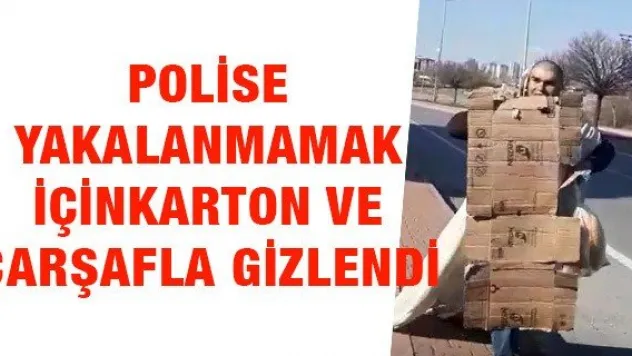Polise yakalanmamak için karton ve çarşafla gizlendi