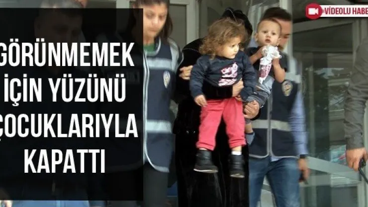 Görünmemek için yüzünü çocuklarıyla kapattı